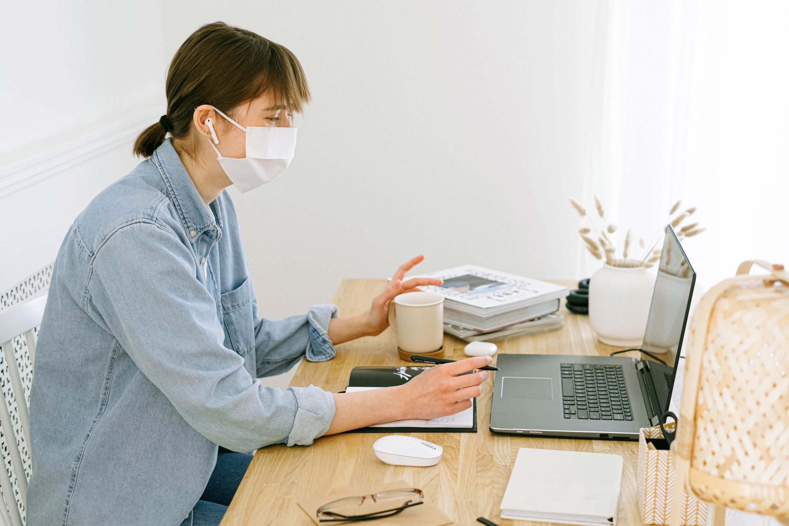 woman-with-face-mask-looking-at-a-laptop-4240606